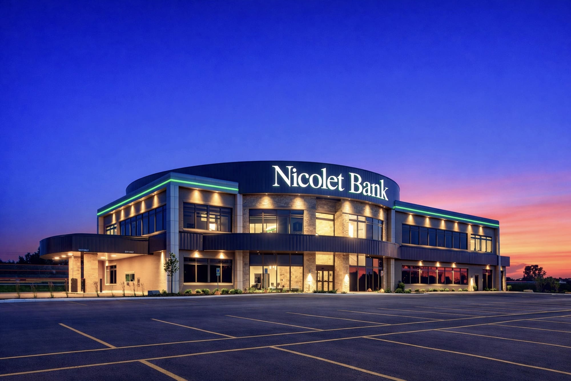 Commercial real estate photo of a modern two-story Nicolet Bank with bright signage, large windows, and vacant parking lot at sunset.