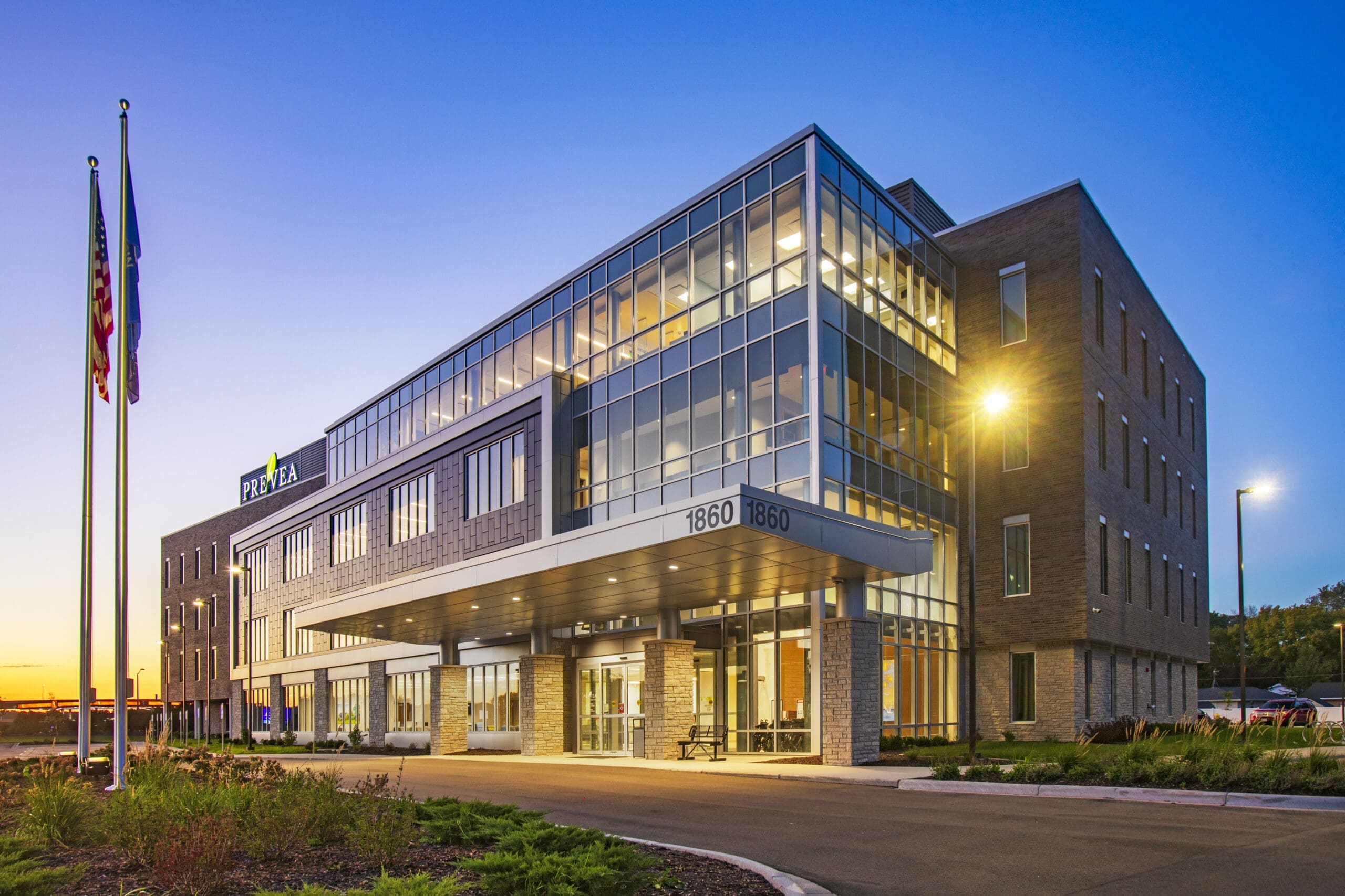 Premium commercial real estate property at 1860, modern multi-story office building with large windows, sunset lighting, and landscaping. Premium commercial real estate property at 1860, modern multi-story office building with large windows, sunset lighting, and landscaping.