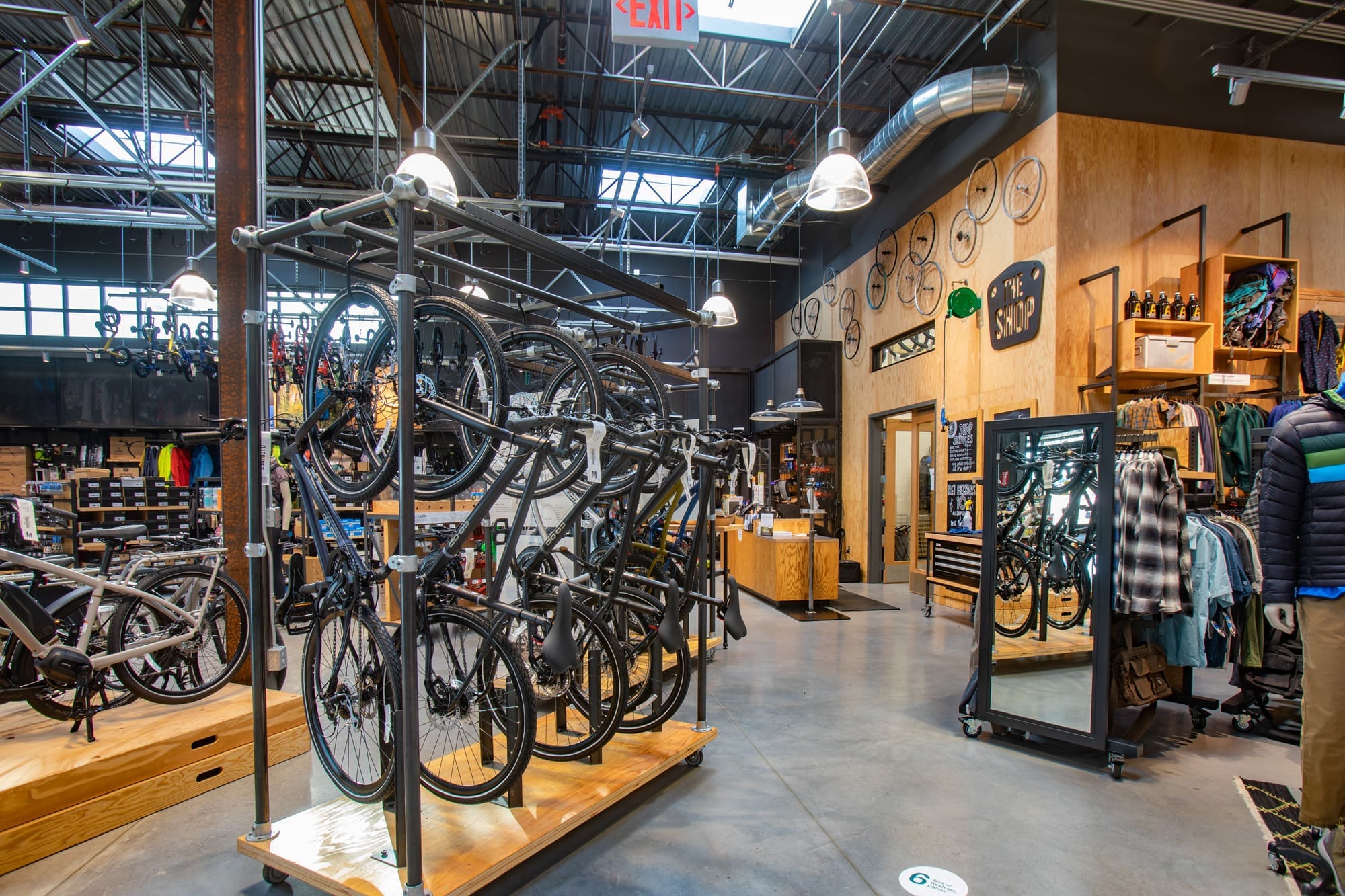 Commercial property interior of a modern bicycle shop featuring display racks, shelving, and industrial lighting for real estate listing.