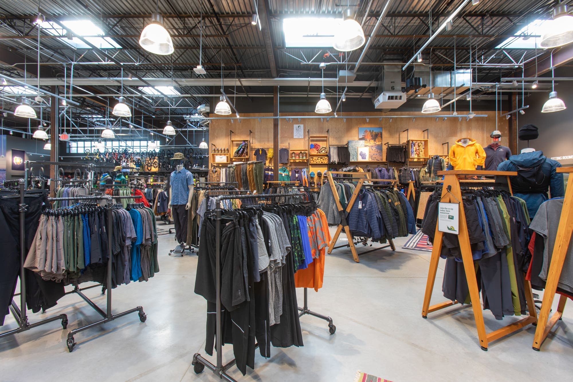 Commercial retail space interior featuring clothing racks, mannequins, and bright lighting, ideal for property marketing photos.
