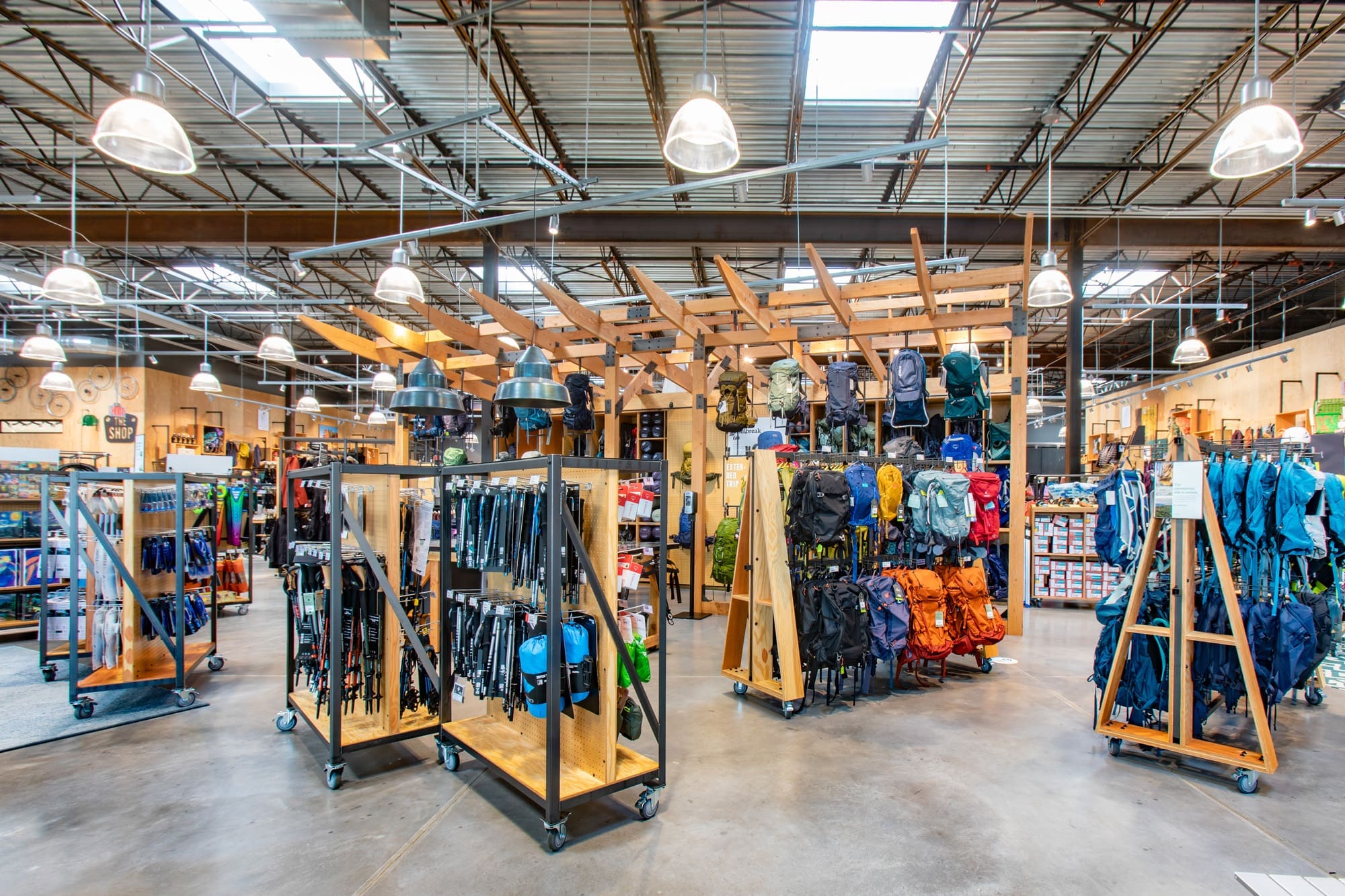 Commercial retail space featuring an outdoor gear store interior with organized racks, bright lighting, and spacious open layout.