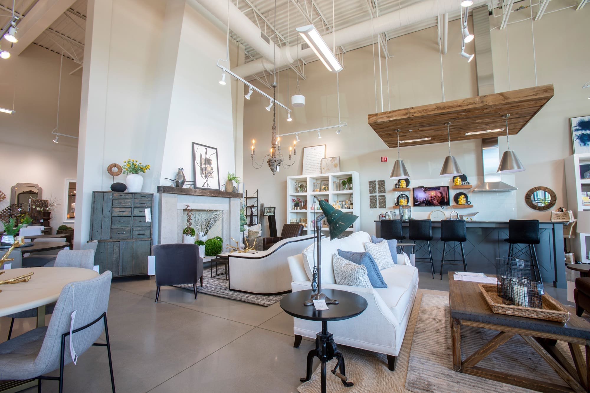 Commercial real estate interior with modern furniture, décor, and lighting in a spacious, well-lit showroom designed for property display.